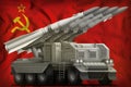 Tactical short range ballistic missile on the Soviet Union SSSR, USSR national flag background. 9 May, Victory day concept. 3d