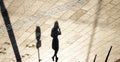 Tactile floor paving indicators and shadow silhouette of a person walking alone in sepia black and white Royalty Free Stock Photo