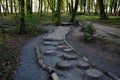 Tactile path for bare feet awakens the senses and uneven endings on the feet alternating different materials wood stone gravel Royalty Free Stock Photo