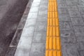 Tactile paving for blind handicap on tiles pathway. Royalty Free Stock Photo