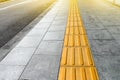 Tactile paving for blind handicap on tiles pathway Royalty Free Stock Photo