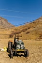 Tactor with disk harrow on plowing field.