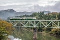 Tadami river with bridge and train