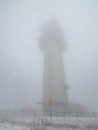 Tadiocommunication tower in fog. Klinovec Mountain