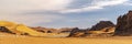 Panoramic view of Sahara Desert sand dune and rocky mountain off road trip 4X4 cars.