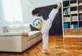 Boy exercising at home in living room Royalty Free Stock Photo