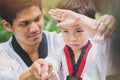 Taekwondo master black belt teaching kid to fight guard