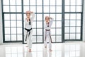 Taekwondo teacher and student show action of different postures in the room with glass windows