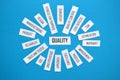 QUALITY paper tag cloud on blue background Royalty Free Stock Photo