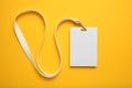 Tag id pass, plastic identification on yellow background. White blank badge mockup