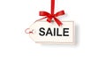 A tag with the word saile on it is hanging from a red ribbon Royalty Free Stock Photo
