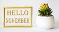 Tag with the words hello october in a gold frame on a white background Royalty Free Stock Photo