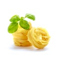 Tagliatelle italian pasta with basil isolated on white background. Royalty Free Stock Photo