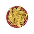 Tagliatelle noodles in a red bowl Isolated on white background.