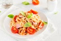 Tagliatelle pasta with ham and tomatoes Royalty Free Stock Photo