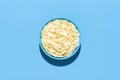 Tagliatelle pasta top view. Cooked noodles in a bowl on a blue background