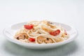 Tagliatelle sauted with tomatoes and mushrooms