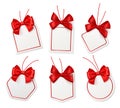 Tags with red bows. Blank white price labels with silk scarlet ribbons for christmas or birthday packaging gift vector Royalty Free Stock Photo