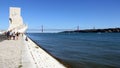 Tagus embankment in Belem, Monument to Discoverers and the 25th of April Bridge in the background, Lisbon, Portugal