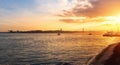 Tagus River Rio Tejo at sunset with 25 de Abril Bridge and Sanctuary of Christ the King on background - Lisbon, Portugal Royalty Free Stock Photo