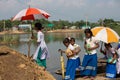 Girls getting down from boat to attend school. Education for girls. Girls happy to get