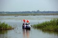 School students are in the middle of the river crossing the flood water to attend school in rural village. Royalty Free Stock Photo