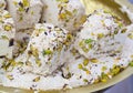 Tahini-based halva with pistachios, bowl of halava sweets