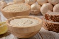 Wooden bowl and spoon with white sesame seeds Royalty Free Stock Photo