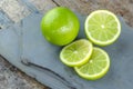 Tahitian limes on a stone . Royalty Free Stock Photo