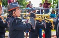 Tahlequah USA High school band members in cowboy hats and black uniforms and gloves play trumpets in front of reviewing Royalty Free Stock Photo