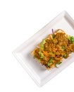 tahu goreng with peanut sauce served in a dish isolated on white background side view