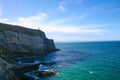 Taiaroa Head is a headland at the end of the Otago Peninsula in New Zealand, overlooking the mouth of the Otago Harbour. The cape