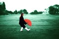 Taichi wushu master woman in the Outdoors move with the fan Royalty Free Stock Photo