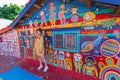 TAICHUNG,TAIWAN-NOVEMBER 30,2019:Asian female tourists visit the old house at Rainbow Village, colorful paintings on the walls in Royalty Free Stock Photo