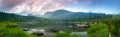 Taiga. Lake and mountains at dawn with beautiful clouds. Panorama Royalty Free Stock Photo