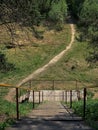 Taiga terrain, wooden staircase with metal railings leading down to the trail. A square in Surgut Russia. Spring. Royalty Free Stock Photo