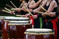 Taiko drummers drumming on Japanese Drums