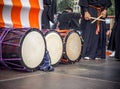 Taiko drums o-kedo are in a row and japanese drummers on the Yagura stage get ready to play. Musical instrument of Asia