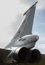 Tail of an airplane and turbine against the sky.