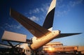 Tail fin of airplane at airport sunset Royalty Free Stock Photo