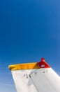 Tail fin, rudder and beacon lights, small single engine airplane with old paint and bright blue sky. Royalty Free Stock Photo