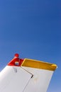 Tail fin, rudder and beacon lights, small single engine airplane with old paint and bright blue sky. Royalty Free Stock Photo