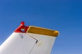 Tail fin, rudder and beacon lights, small single engine airplane with old paint and bright blue sky. Royalty Free Stock Photo