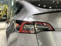 tail lights of Tesla car model Y in silver Mercury Silver Metallic color in Studio, electric vehicle in showroomr, alternative