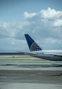 Tail of a United Airlines jet on an airport runway Royalty Free Stock Photo