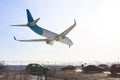 Tail view of landing airplane. Aircraft flying over highway. Road with high traffic near airport runway. Type of transport compar Royalty Free Stock Photo