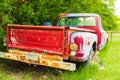 Tailgate Of Abandoned Vintage Red Truck Parked In A Field On A Farm