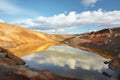 tailings pond in a remote mine, reflecting the sky