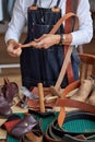 tailor in apron working with leather belt at workshop, craftsman Royalty Free Stock Photo