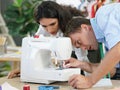 The tailor is checking the authenticity of the sewing machine